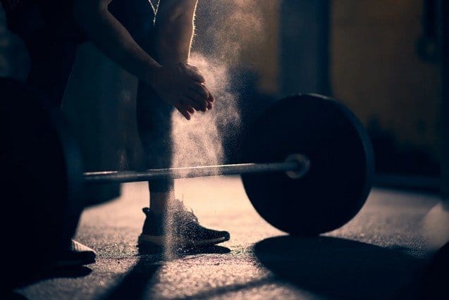 A person lifting weights with powder
AI-generated content may be incorrect.