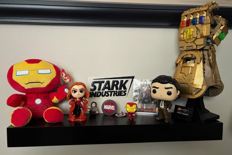 Shelf of Marvel memorabilia and collectibles, each one a gift — a snapshot of fandom and identity.
